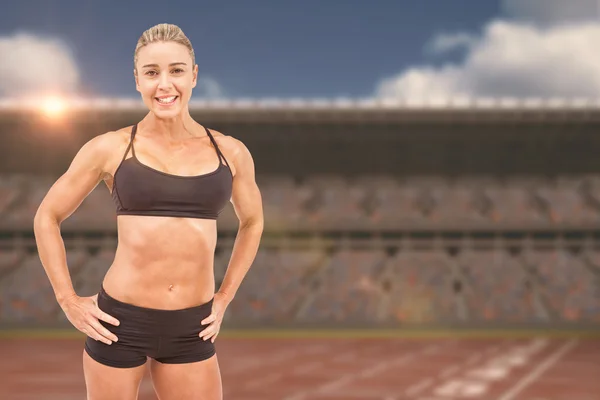Athlete posing with hands on hips — Stock Photo, Image