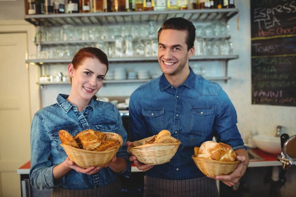 Baristas offering breads at coffee shop — Stock Photo, Image