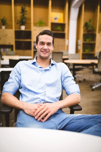 Businessman sitting in creative office — Stock Photo, Image