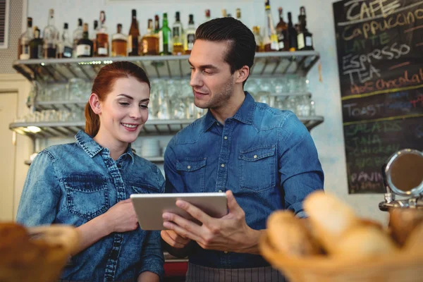 Baristas with digital tablet at cafe — Stock Photo, Image
