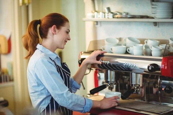 Worker using machinery at cafe — Stock Photo, Image