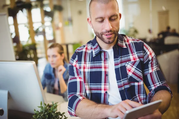 Businesman using tablet at creative office — Stock Photo, Image