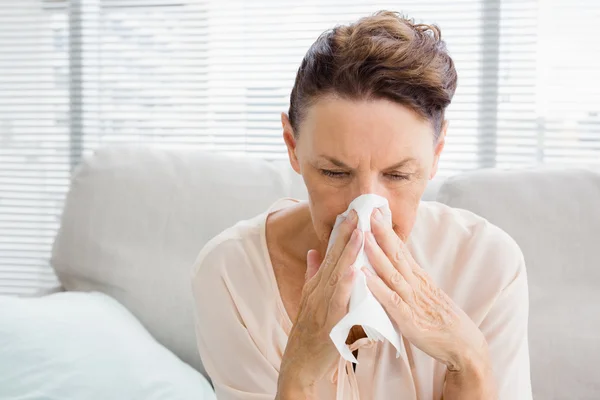 Mature woman with blowing nose — Stock Photo, Image