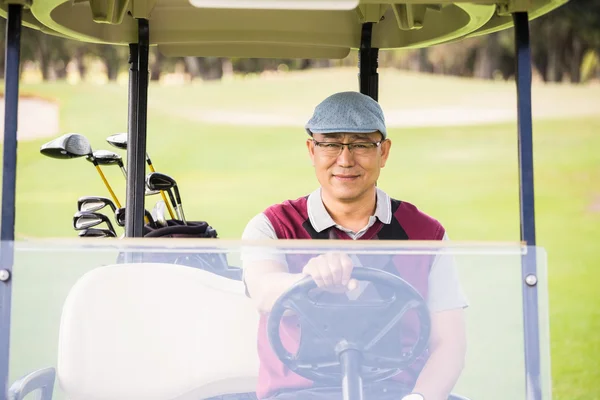 Golfista alla guida di un golf buggy — Foto Stock