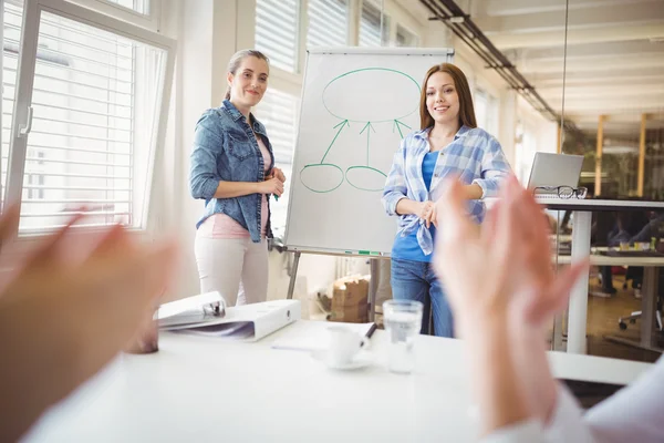 Businesswoman with colleague giving presentation — Stock Photo, Image