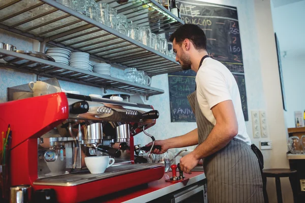 Barista working by coffee maker at cafe — Stock Photo, Image