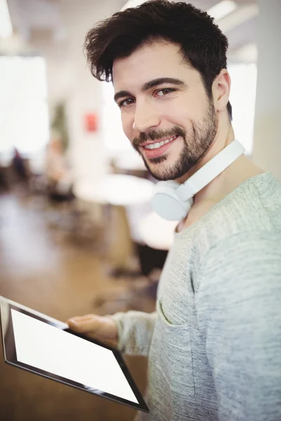 Businessman holding tablet in office — Stock Photo, Image