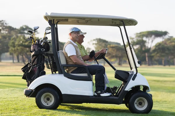 Golfer friends sitting in golf buggy — Stock Photo, Image