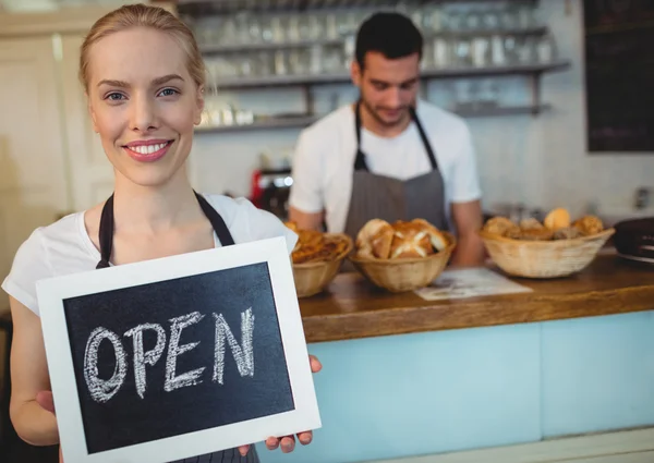 Confident waitress holding chalkboard — Stock Photo, Image