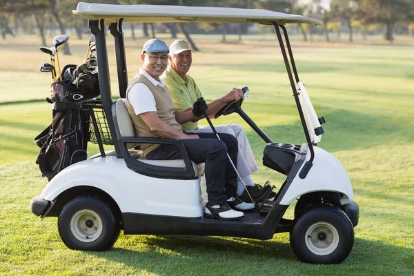 Male golfer friends sitting in golf buggy — Stock Photo, Image