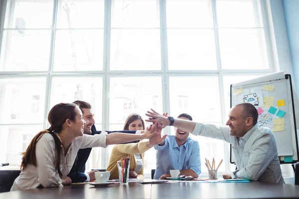 Colleagues high-five in meeting room — Stock Photo, Image