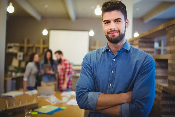 Creative businessman with arms crossed — Stock Photo, Image