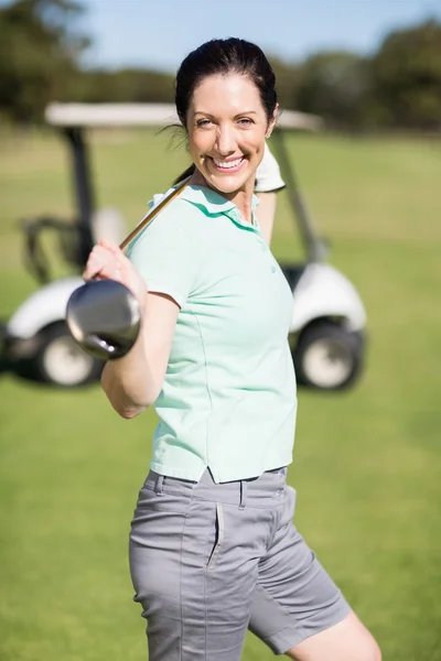 Donna allegra che trasporta golf club — Foto Stock