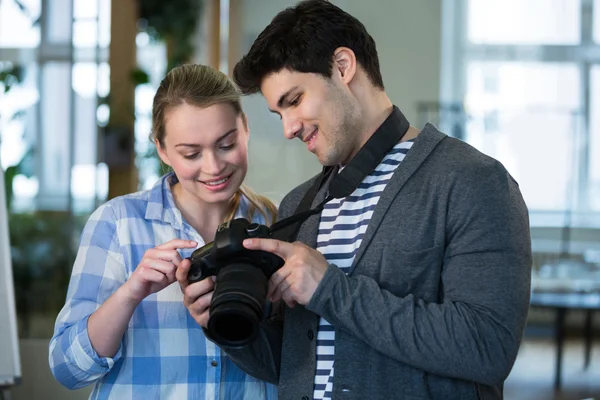 Photographer showing picture to colleague — Stock Photo, Image