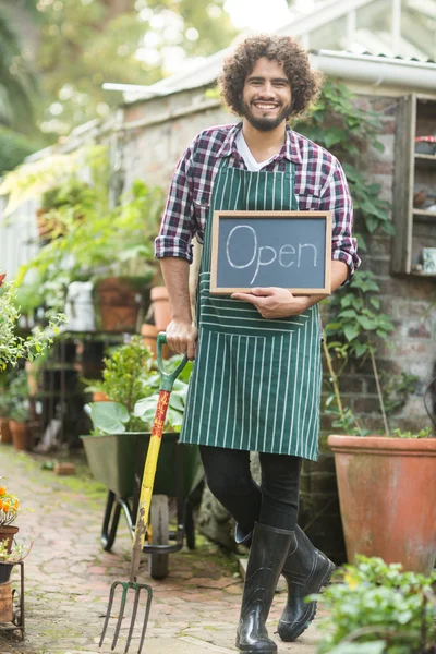 園芸のフォークを保持オープン サインを持つ男性庭師 — ストック写真