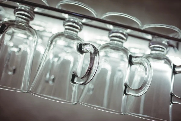 Tilt shot of pint mugs on rack at bar — Stock Photo, Image
