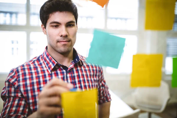 Empresario escribiendo en notas adhesivas —  Fotos de Stock