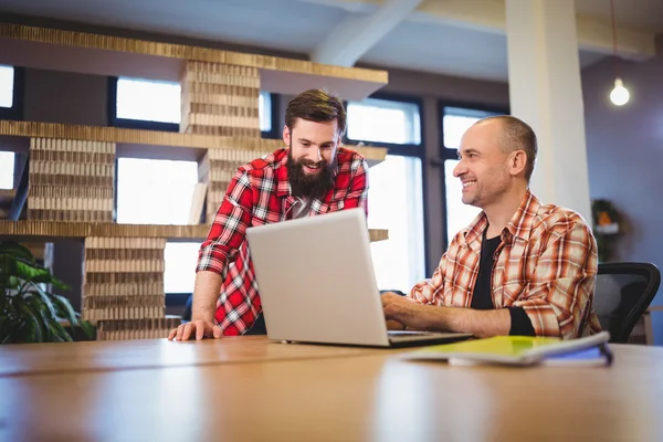 Coworkers discussing over laptop — Stock Photo, Image
