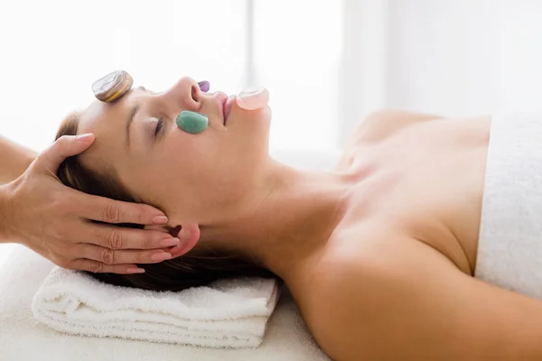 Masseur giving facial stone massage to woman — Stock Photo, Image