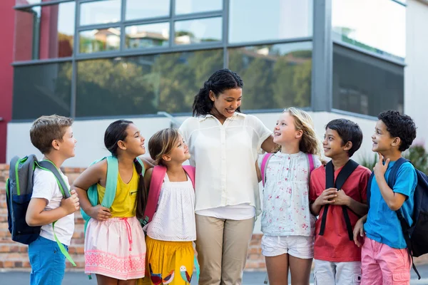 Cheerful female teacher with children — Stock Photo, Image