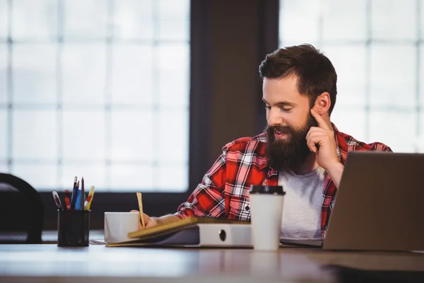 Hipster working at desk — Stock Photo, Image