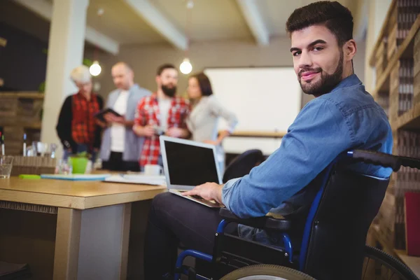 Smart disabled businessman using laptop — Stock Photo, Image