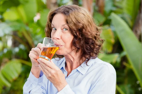 Mature woman drinking herbal tea — Stock Photo, Image