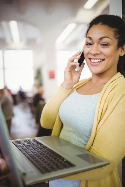 Businesswoman holding laptop — Stock Photo, Image