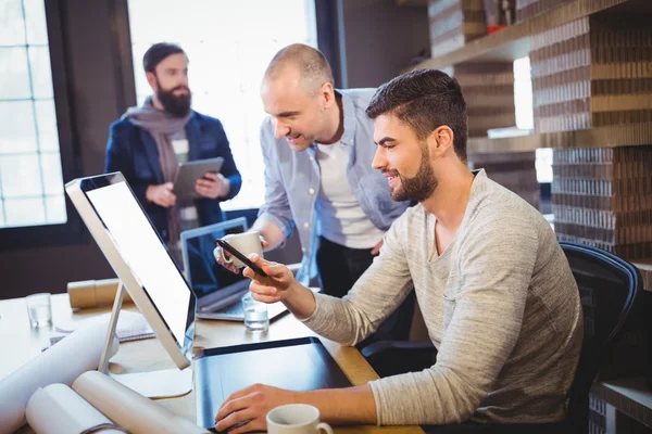 Coworkers discussing over computer — Stock Photo, Image