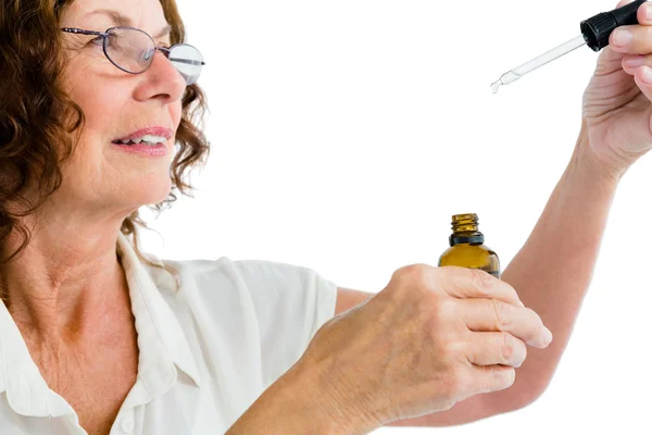 Woman holding dropper with medicine — Stock Photo, Image