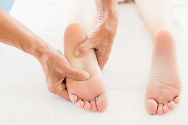 Masajista dando masaje de pies a la mujer — Foto de Stock