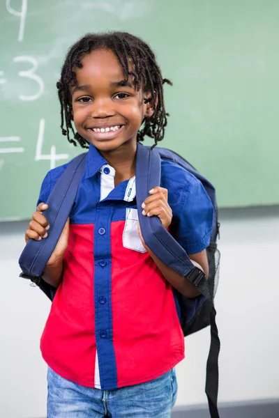Boy standing against board in classroom — Stock Photo, Image