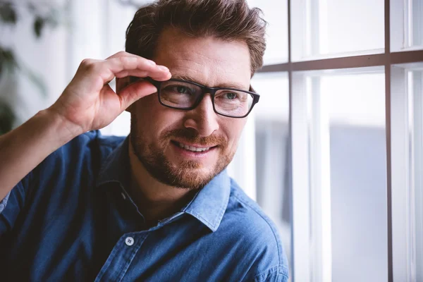 Executive by window at creative office — Stock Photo, Image