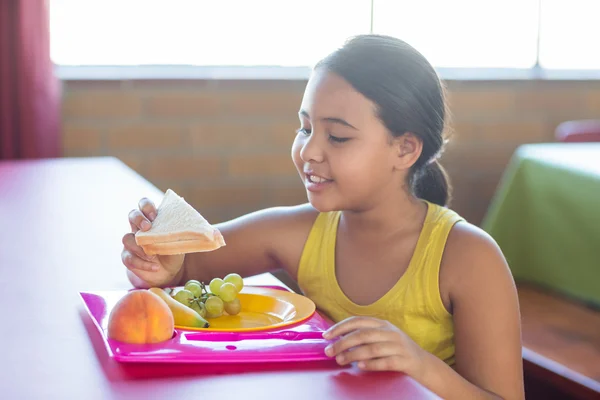 Schoolgirl having meal — Stock Photo, Image