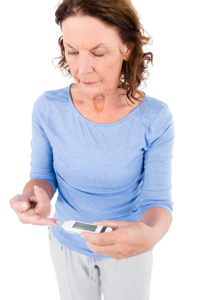 Mature woman taking blood sample — Stock Photo, Image