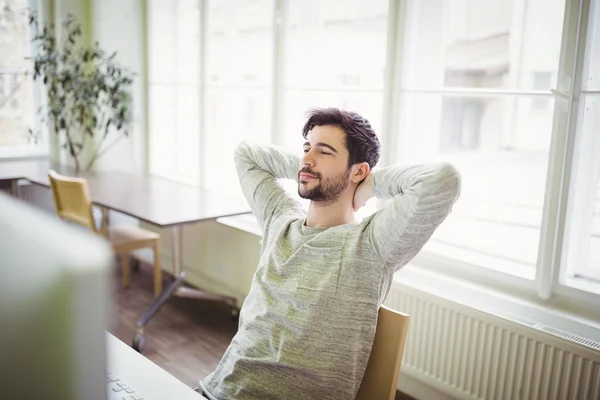 Businessman relaxing in creative office — Stock Photo, Image