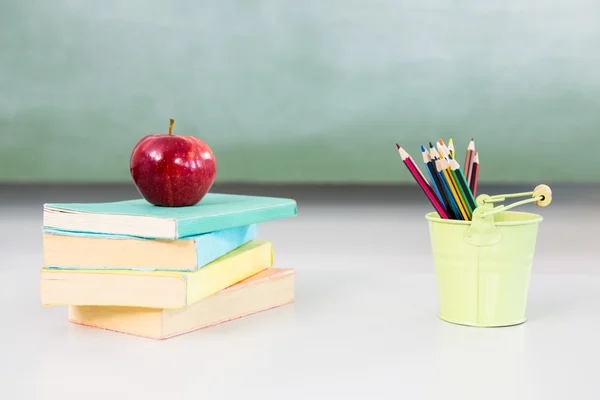 Apple com livros e organizador de mesa — Fotografia de Stock