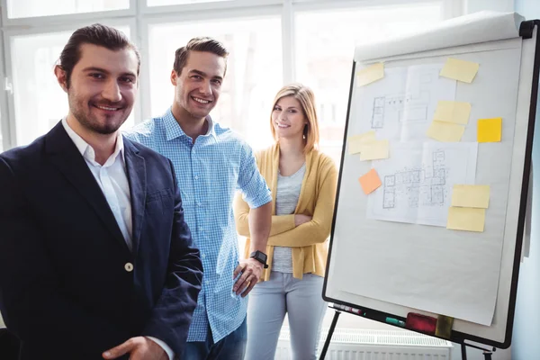 Interior designers standing near board — Stock Photo, Image