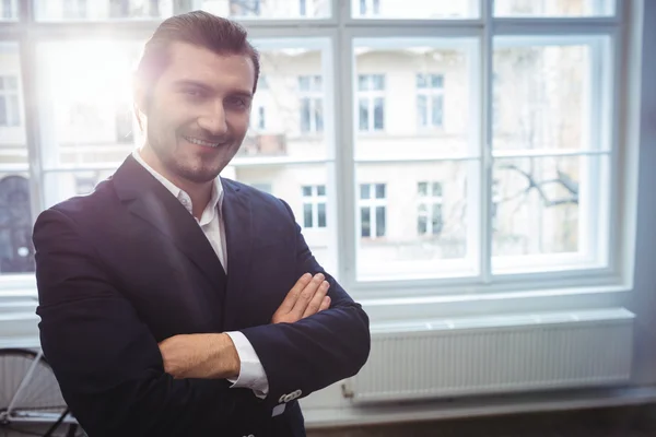 Smiling businessman in creative office — Stock Photo, Image
