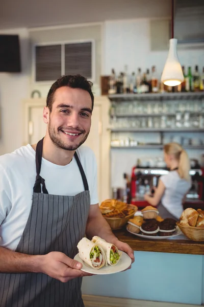 Waiter with fresh rolls at cafe — Stock Photo, Image