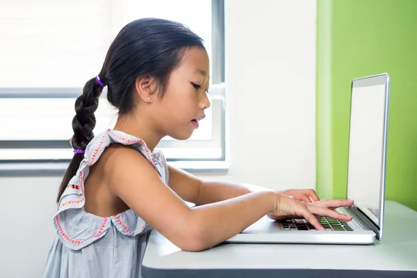 Meisje met laptop in de klas — Stockfoto