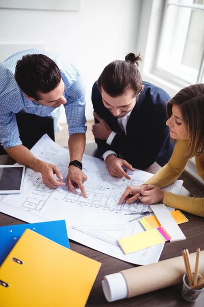 Business people discussing on blueprint — Stock Photo, Image