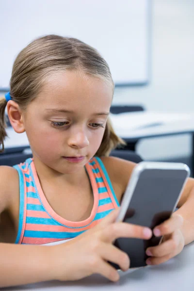 Elementary girl using mobile phone — Stock Photo, Image