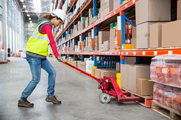 Worker pushing trolley with boxes — Stock Photo, Image