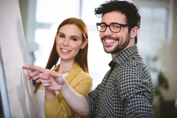 Business people pointing on whiteboard — Stock Photo, Image