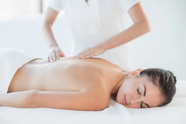 Relaxed naked woman receiving massage — Stock Photo, Image