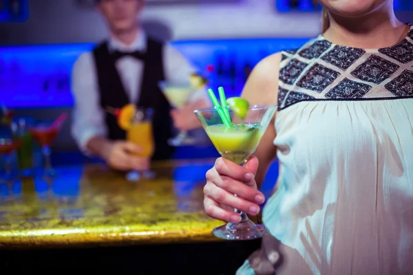 Donna con bicchiere da cocktail accanto al barista — Foto Stock