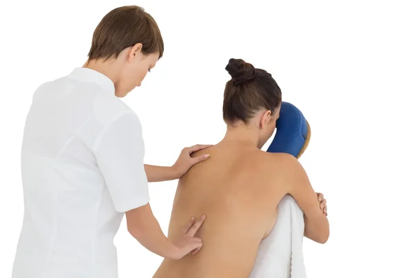 Woman being massaged on chair by masseuse — Stock Photo, Image