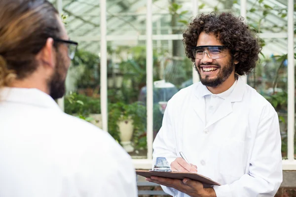 Male scientists smiling while discussing — Stock Photo, Image