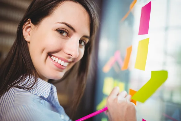 Creative businesswoman writing on sticky notes — Stock Photo, Image